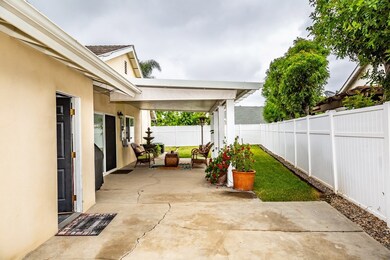 Side patio area and access to garage from side yard.