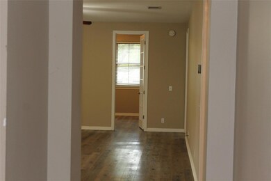 Hall with wood-type flooring and baseboards