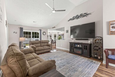 Living room featuring ceiling fan, a textured ceil