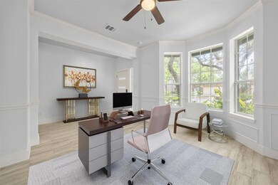 Home office with crown molding, ceiling fan, and 