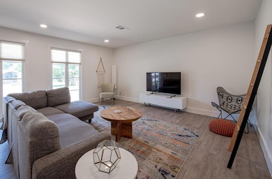 Living area with wood finished floors, baseboards