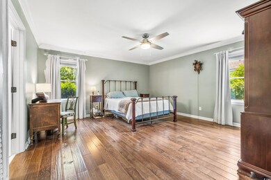 Bedroom with crown molding, hardwood / wood-style 