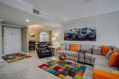 Living room with crown molding and light tile patt