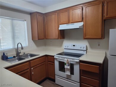 Kitchen featuring white appliances, under cabinet