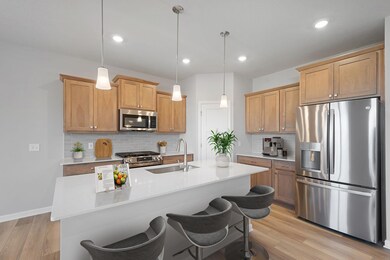 The Kitchen features wood stained cabinetry and a large walk in pantry.