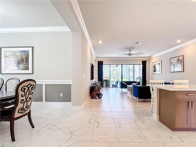 Dining room with crown molding and ceiling fan