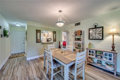 Dining area looking to kitchen and entry door.