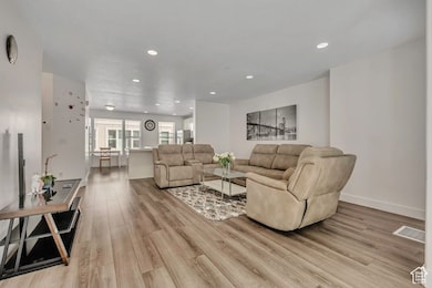 Living room featuring light wood-type flooring and recessed lighting