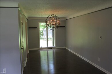 Dining room is also complimented with the newer wood floors and fresh paint and features a decorative lighting fixture.