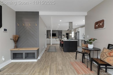 Living room featuring light wood-type flooring and recessed lighting