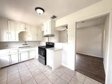 The inviting eat-in kitchen features crisp white c