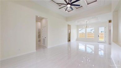 Unfurnished room featuring coffered ceiling, ceiling fan, and beam ceiling