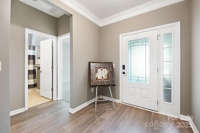 Foyer with 2 beds and full bath to the side.