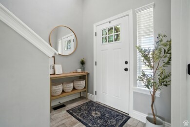 Foyer with light wood-style floors