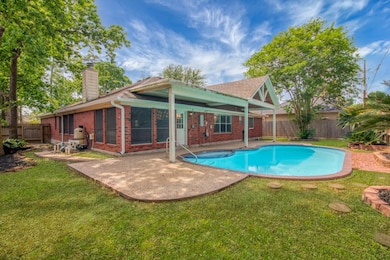 Charming backyard featuring a covered patio, invit