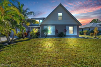 Back house at dusk with a yard