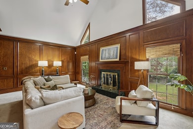The stunning Two-Story Great Room serves as a dramatic focal point, accented by Original Wood Paneling that adds warmth and timeless character.