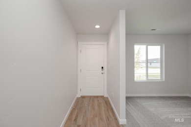 Hallway with recessed lighting and light wood finished floors