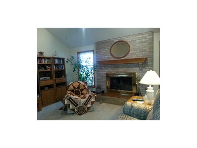 Beautiful Brick Fireplace features wood mantle wit