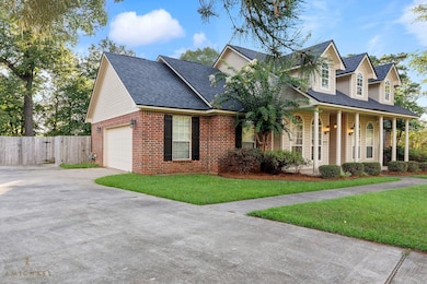 View of front facade featuring roof with shingles, driveway, a porch, brick siding, and a garage