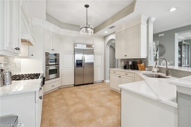 Kitchen featuring kitchen peninsula, stainless steel appliances, backsplash, sink, and pendant lighting