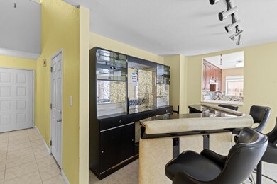 The bright & cheery living room has a bar area at one end *it is movable.