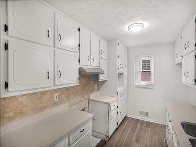 Kitchen with wood finished floors, under cabinet r