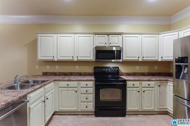 Kitchen has tile floors and recess lighting.
