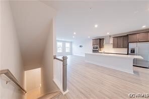 Kitchen featuring stainless steel fridge, exhaust