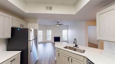 Kitchen with visible vents, light countertops, a s