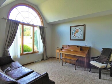 Off the main entry and adjacent to the dining room is the living room.  This space offers a vaulted ceiling and beautiful Andersen palladian style picture window.