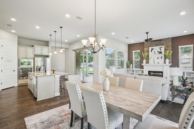 Dining area with a ceiling fan, dark wood finishe