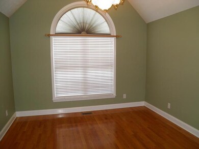 Formal living room is located at the front of the home.  Lovely transom window and vaulted ceiling.  