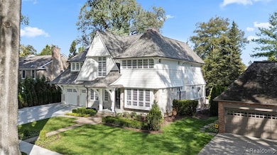 View of front of house with a front yard, concrete driveway, and a chimney