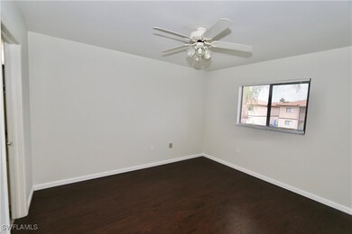 Empty room featuring dark wood finished floors, ba