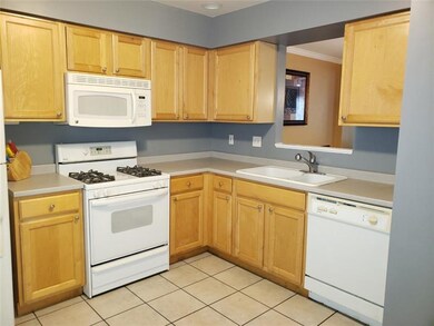 Kitchen with L shaped counter, tile flooring, conv