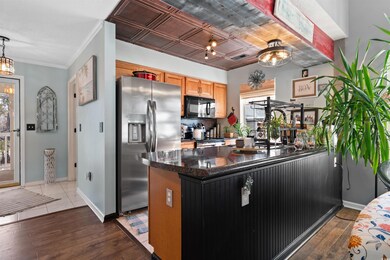 Kitchen featuring stainless steel fridge with ice 
