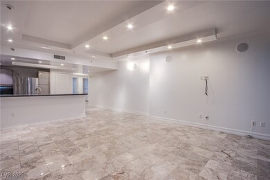 Unfurnished living room featuring a raised ceiling