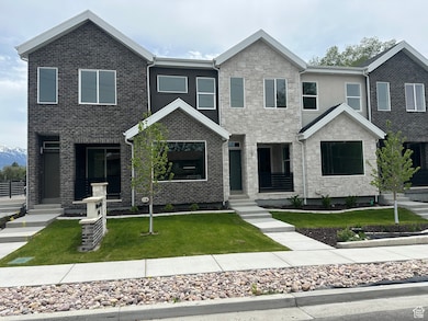 View of front of home featuring a front lawn and stone siding