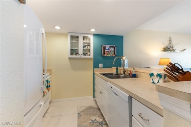 Kitchen featuring light tile patterned floors, lig