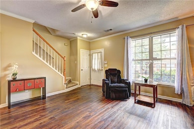 Sitting room with a textured ceiling, wood finishe