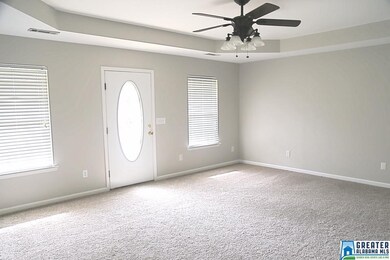 Large living room includes tray ceilings and plent