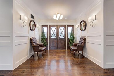 Foyer with an inviting chandelier, hardwood / wood