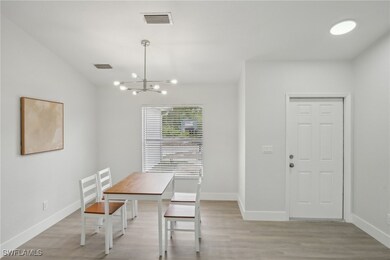 Dining area with visible vents, light wood-style f