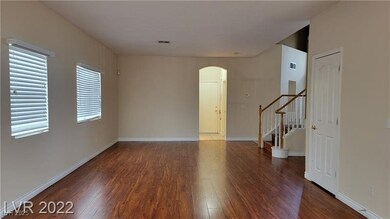 Spare room with arched walkways, wood finished flo
