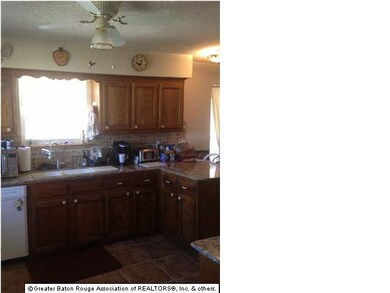 Granite counter top with tile backsplash and slide