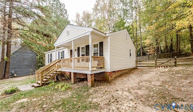 View of front of home featuring stairway, crawl space, and a porch