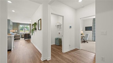 Corridor with wood finished floors and recessed lighting