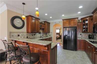 Granite and tile kitchen-double ovens-oil rubbed bronze fixtures. Seller recently added a tile back splash accent.
