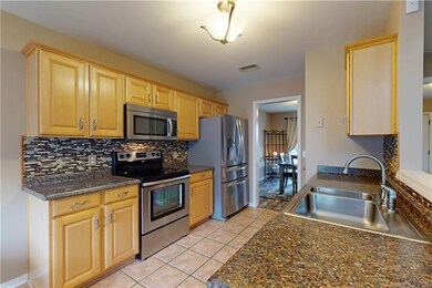 Kitchen features stainless steel appliances and be